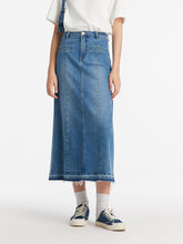 A lady wears an A-line denim skirt.